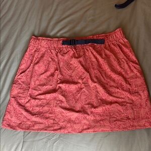 Woman’s orange athletic/hiking skirt